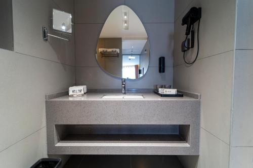 a bathroom with a sink and a mirror at Hill Top Hotel in Aqaba