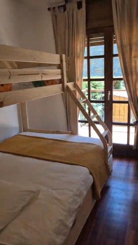 two bunk beds in a room with a window at Can Vibru Vilallonga in Vilallonga de Ter