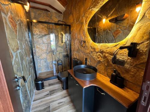 a bathroom with a sink and a stone wall at Olinda Hotel & Spa in Şile