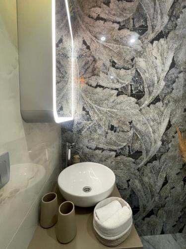 a bathroom with a white toilet and a sink at Lounge garden sea relax in Valencia