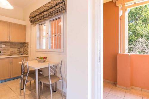 a kitchen with a table and chairs and a window at BELLA De LUX APTS in Ýpsos
