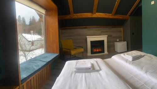 a bedroom with a bed and a fireplace at MiShelter in Migovo