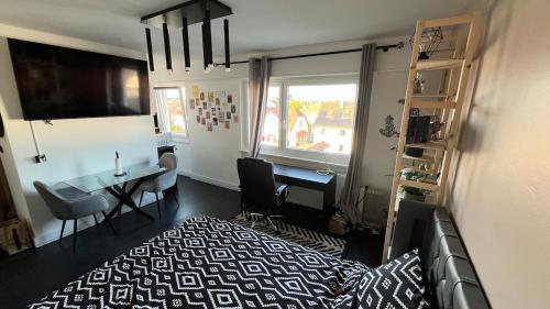 a bedroom with a bed and a desk and a window at Appartement cosy in Saint-Louis