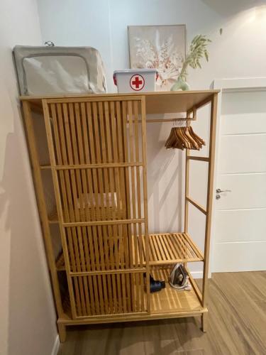 a wooden stand with a bird cage on it at Lounge garden sea relax in Valencia