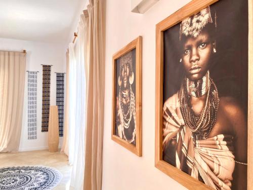 a room with a painting of a woman on the wall at Luxury Lions Villas Zanzibar - with Private Cook&Infinity Pools in Kiwengwa
