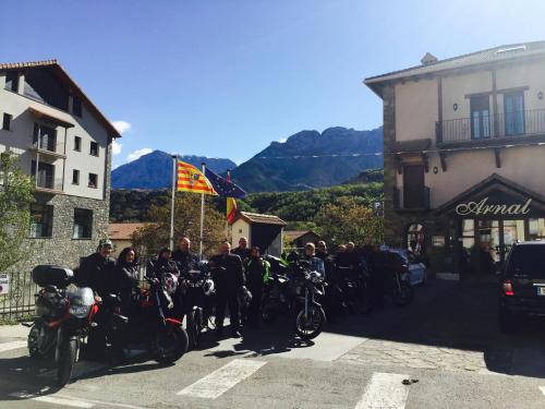 a group of people on motorcycles parked in a street at Hotel Arnal in Escalona