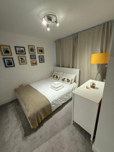 a bedroom with a bed and a table with a lamp at Double Bedroom With Dedicated Private Bathroom in Edinburgh