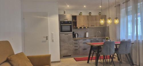 a kitchen with a table with chairs and a counter top at Renatas Ferienwohnung Maria in Sasbachwalden