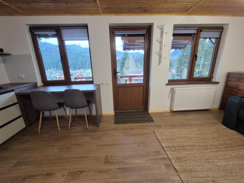 a kitchen with a table and chairs in a room at Бриндуш in Tatariv