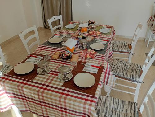 a table with a red and white checkered table cloth at B&B Villa Bello in Otranto