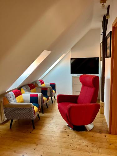 a living room with many chairs and a flat screen tv at Chalupa Vale in Mohelno