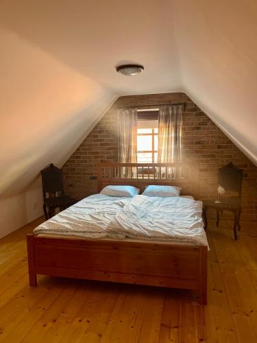 a bedroom with a large bed in a attic at Chalupa Vale in Mohelno