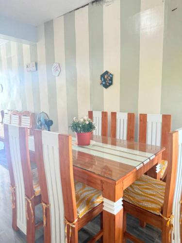 a dining room table with chairs and a tableasteryasteryasteryasteryasteryasteryastery at Mountain cove villa in Pagudpud