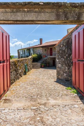 an entrance to a house with red doors at House Sopo in Vila Nova de Cerveira