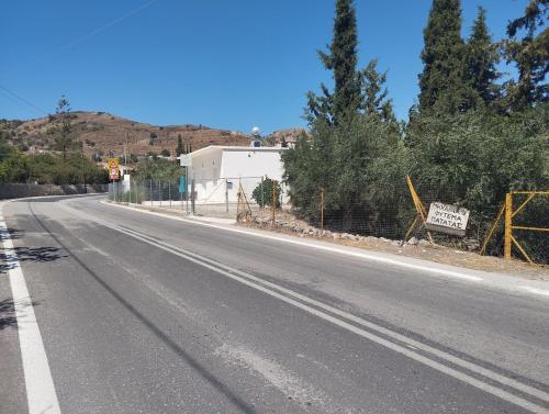 an empty road with a sign on the side of it at katerina's house in Kondós