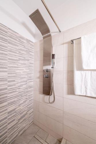 a bathroom with a shower with a glass door at katerina's house in Kondós