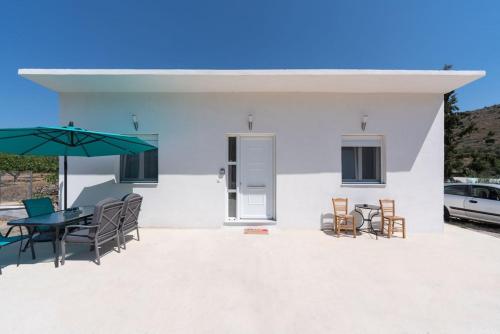 a patio with a table and chairs and an umbrella at katerina's house in Kondós