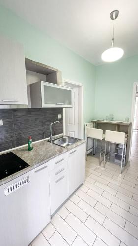 a kitchen with a sink and a counter top at Seaside Apartments - Adults Only in Yenion