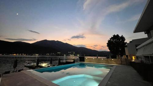 a swimming pool with a view of the mountains at Seaside Apartments - Adults Only in Yenion