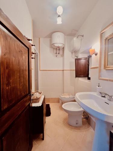 a bathroom with a sink and a toilet and a sink at La casa di Nonna Carissima in Villalago