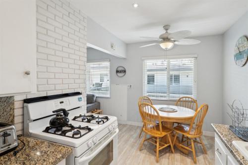 a kitchen with a stove and a table with chairs at 4980 Sandyland Road #215 in Carpinteria