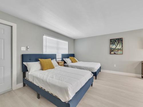 a bedroom with two beds and a window at Beachside 1BR Apt – Steps to Hollywood Dania in Dania Beach