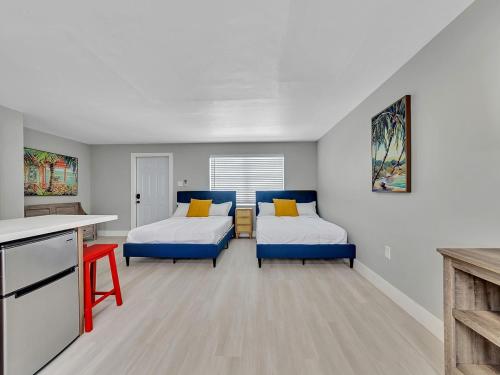a small room with two beds and a kitchen at Beachside 1BR Apt – Steps to Hollywood Dania in Dania Beach