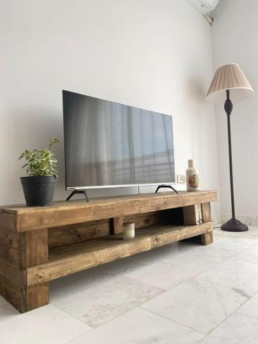 a television on a wooden table in a living room at Seven Sky appartment in Tunis in La Goulette