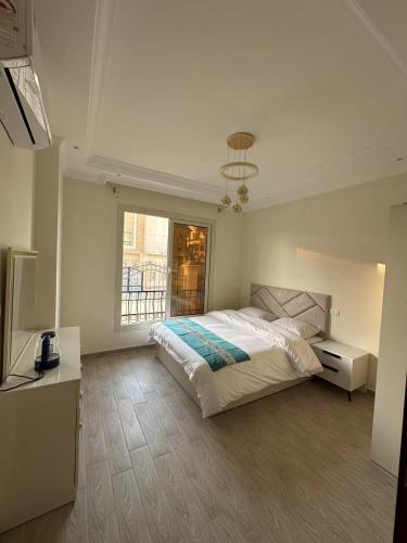 a bedroom with a large bed and a window at 维斯塔公馆 Vista Mansion in New cairo