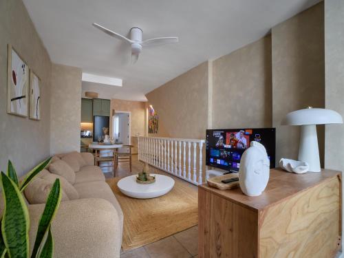 a living room with a couch and a tv at Casa Wanda in Estepona