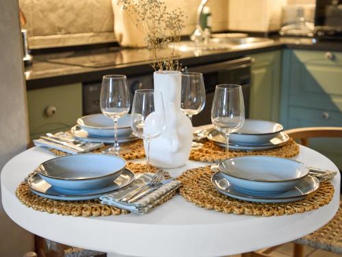 a white table with plates and wine glasses on it at Casa Wanda in Estepona