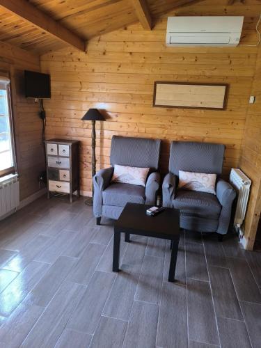 a living room with a couch and a table at Cabañas Miraduero in Aldeadávila de la Ribera