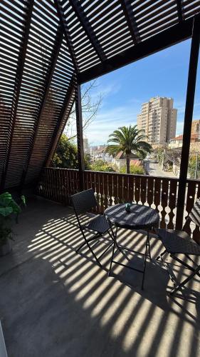 a patio with a table and chairs on a balcony at Tribu in Viña del Mar