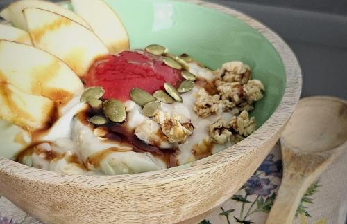 a bowl of food with nuts and fruit in it at Boutique B&B La Quiete del Bosco - A Plant Based Stay in Mesocco