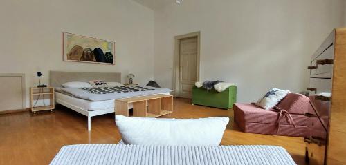 a bedroom with a bed and a chair in it at Villa Rosa Tarvisio in Tarvisio