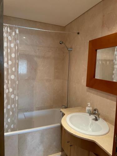 a bathroom with a sink and a bath tub at Lirios Nature, Beach & Pool in Fão