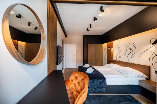 a bedroom with a bed and a mirror at Central Paul Deluxe Apartment - by Open House in Timişoara