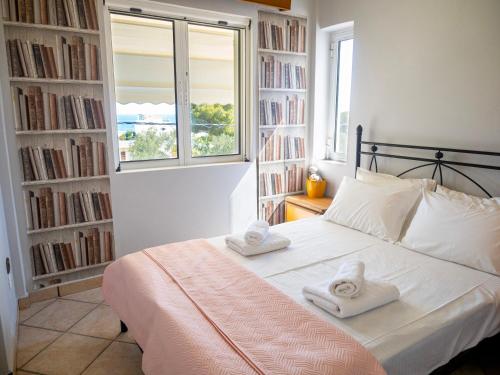 a bedroom with a bed with two towels on it at St Nickolas Guest House in Artemida