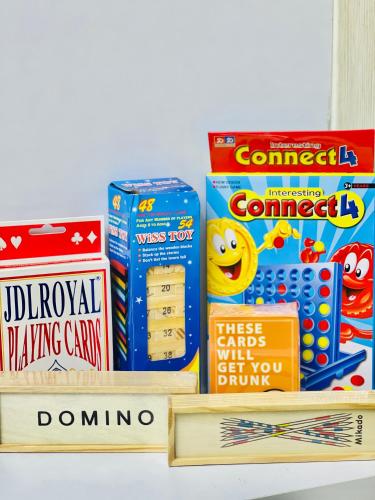 un estante lleno de libros y juegos infantiles en Grey's Suite At Azure North Pampanga, en San Fernando