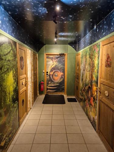 a hallway with paintings on the walls of a room at Sjodalen Hyttetun og Camping in Stuttgongfossen