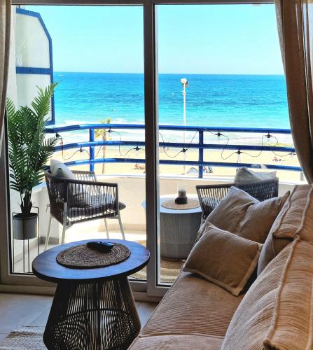 a living room with a couch and a view of the ocean at Rayo Calpe in Calpe