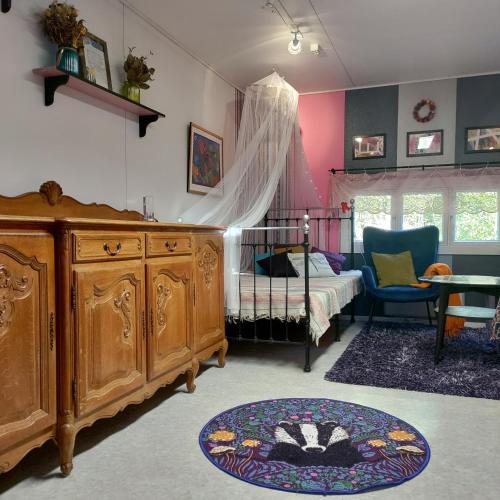 a bedroom with a bed and a dresser and a table at Piha-aitta taajamassa in Parikkala