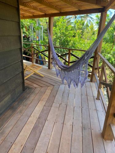 a hammock on the deck of a cabin at Estrela dos Lençóis in Atins