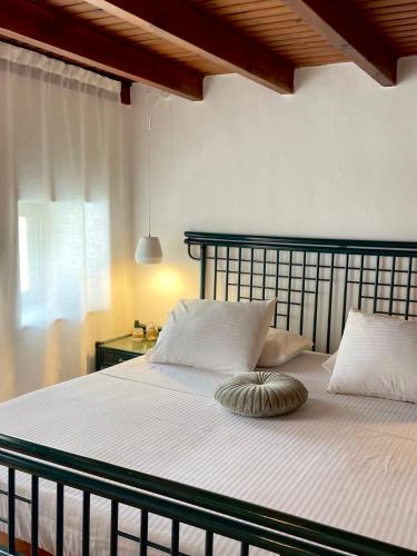a bedroom with a large bed with white sheets at Villa Smaragdi-Despoina in Malona Village