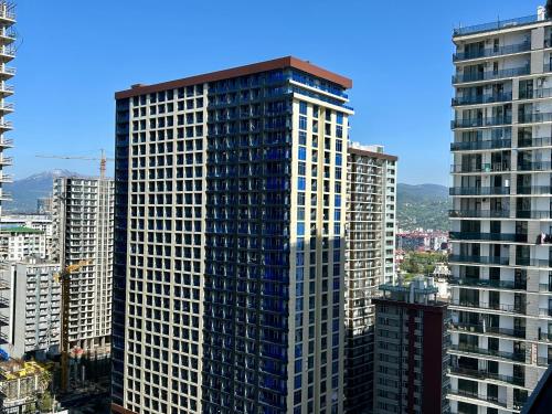 a view of a tall building in a city at Real Beach Tower in Batumi