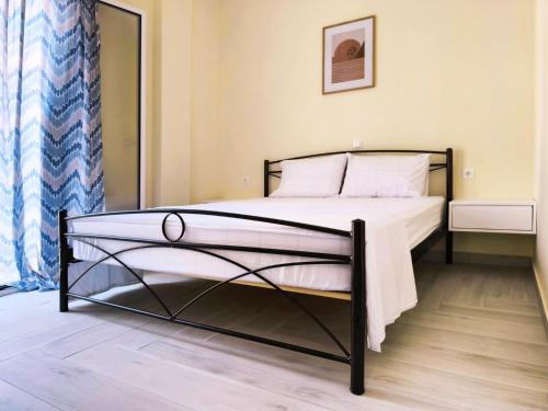 a bedroom with a bed in a room at Sokrates Apartments in Preveza