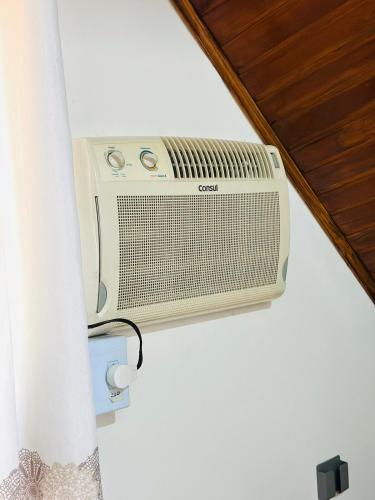 a radio sitting on a wall in a room at Casa em Condominio próximo trevo Cataratas em Cascavel in Cascavel