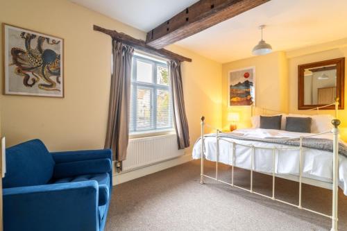 a bedroom with a bed and a chair and a window at Picture Perfect Location Stunning 2 Bedroom Apartment with parking in Norwich