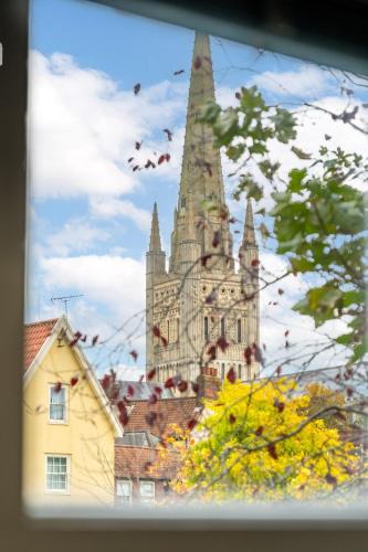 a large building with a steeple on top of a city at Picture Perfect Location Stunning 2 Bedroom Apartment with parking in Norwich