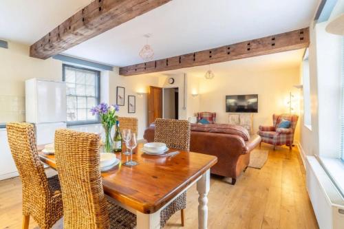 a kitchen and living room with a wooden table and chairs at Picture Perfect Location Stunning 2 Bedroom Apartment with parking in Norwich